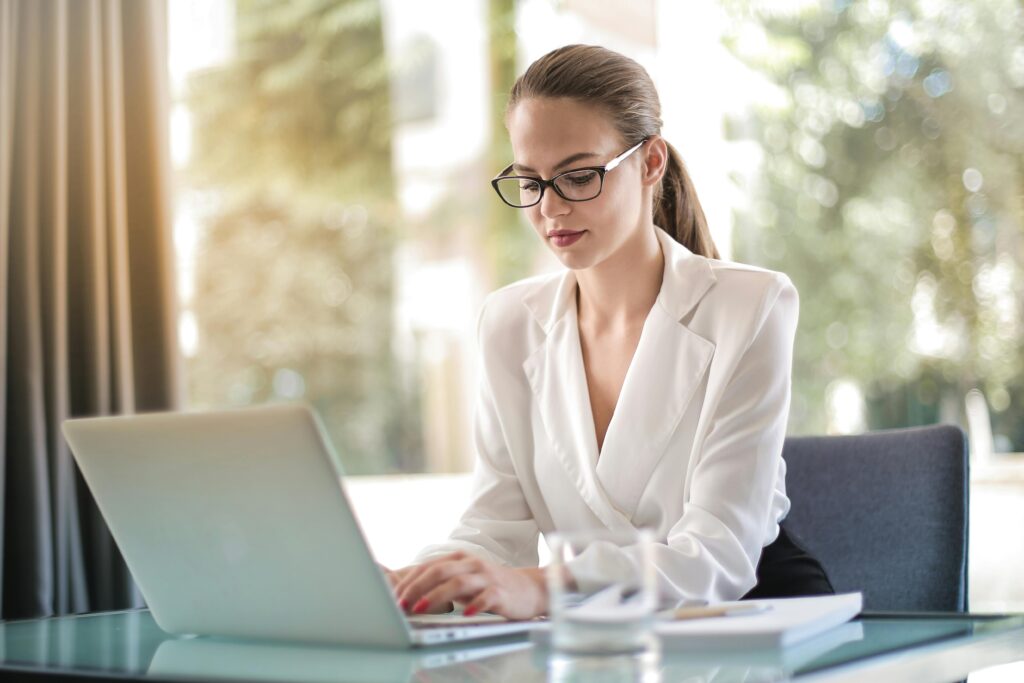 pexels photo 3756681 3756681 Confident businesswoman using a laptop at her desk, focused on her work.